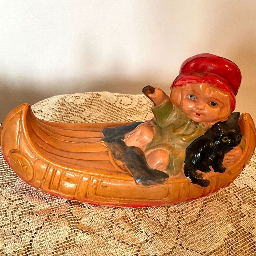 Rare 1920's Antique celluloid toy girl in a canoe; don't miss her!